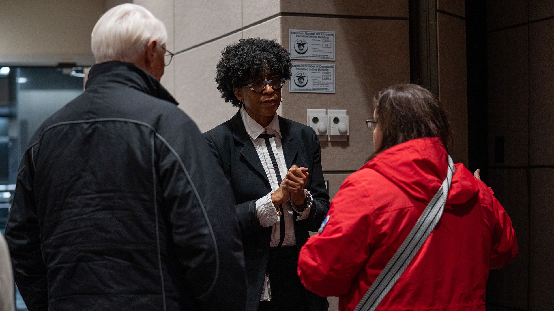 An STRS Ohio associate talks with two STRS Ohio members after a town hall meeting.